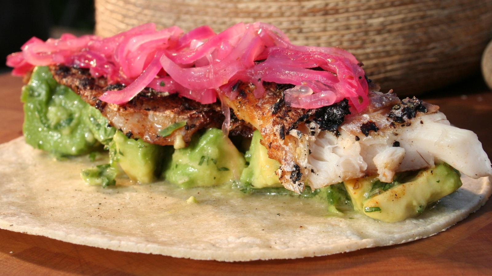 Crisp sea bass tacos with pink pickled onion